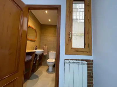 a bathroom with a toilet and a sink and a window at Precioso y espacioso piso in Arenys de Mar