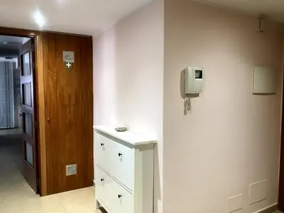 a room with a dresser and a phone on a wall at Vivalidays - Estrella de Mar - Calella in Calella