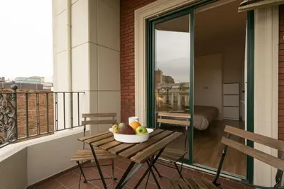a bowl of fruit on a table on a balcony at Gran Vía Suites in Barcelona