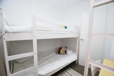 a white bunk bed in a small room at Premia Palm View in Premiá de Mar