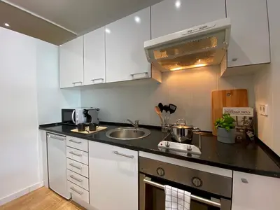 a kitchen with white cabinets and a sink at PISO FILIPPO in Barcelona