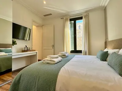 a bedroom with a bed with towels on it at MODERN ELEGANCE by MyRentalHost in Barcelona