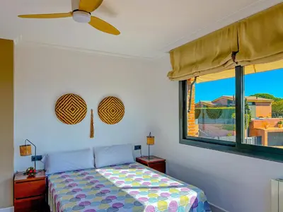 a bedroom with a bed and a ceiling fan at Stylish villa with saltwater pool in Caldes d'Estrac