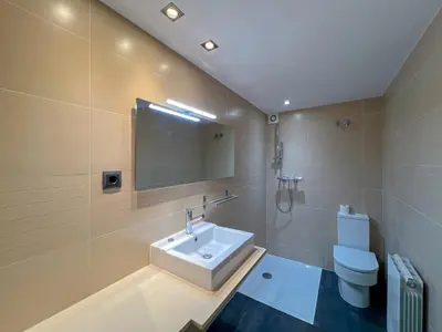 a bathroom with a sink and a toilet at Stylish villa with saltwater pool in Caldes d'Estrac