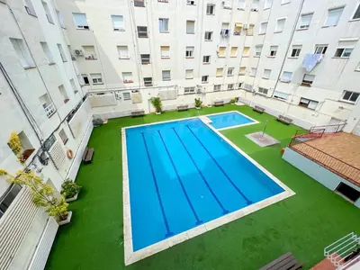 an overhead view of a swimming pool in the middle of a building at Beachfront gateway in Pineda de Mar in Pineda de Mar