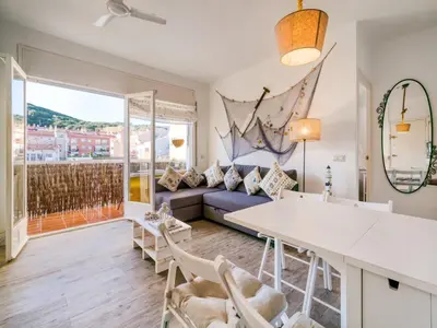 a living room with a couch and a table and chairs at Apartment in Calella near the Beach in Calella