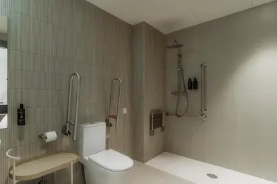 a bathroom with a toilet and a sink at Design Suites by Olala Homes in Hospitalet de Llobregat