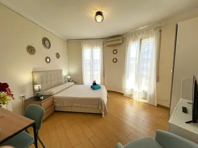 a bedroom with a large bed with a pink blanket at Habitaciones en la calle Valencia in Barcelona