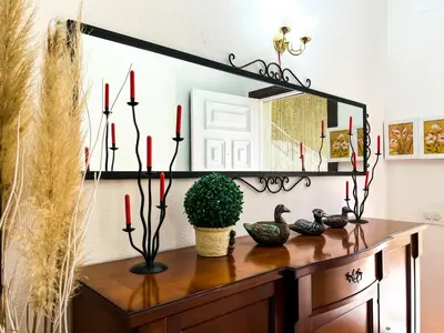a mirror on top of a dresser with candles at Tranquil Villa with Private Pool & views in Sant Cebrià de Vallalta