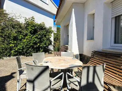 a table and chairs sitting on a patio at Tranquil Villa with Private Pool & views in Sant Cebrià de Vallalta