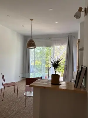 a kitchen and living room with a potted plant at Son Roca Ribes Guest House in Sant Pere de Ribes