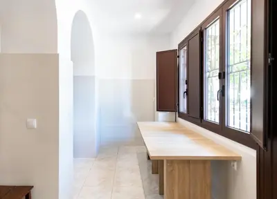 a room with a wooden table and a window at Unique 16th-Century Masia, Pool & Private Events in Barcelona