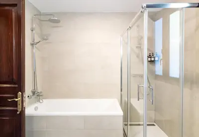 a bathroom with a shower and a bath tub at Unique 16th-Century Masia, Pool & Private Events in Barcelona