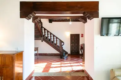 a hallway with a staircase in a house at Unique 16th-Century Masia, Pool & Private Events in Barcelona