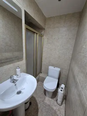 a bathroom with a white toilet and a sink at Marry home in Barcelona