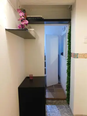 a hallway with a black table in a room at A pasos de la playa en Barcelona! in Barcelona