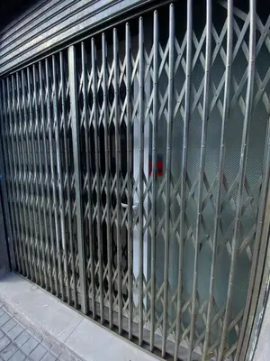 a metal gate on a building with a door at Barcelona Home in Barcelona