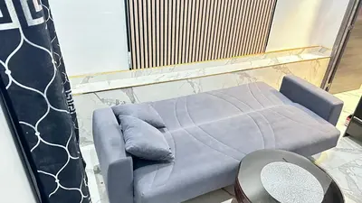 a living room with a couch and a tv at Casa hamburg BCN in Badalona