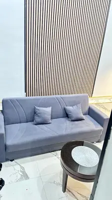a living room with a couch and a table at Casa hamburg BCN in Badalona