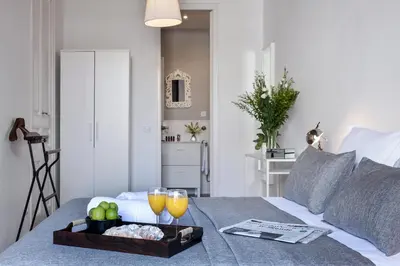 a tray of fruit and drinks on a bed at Aspasios Charming Flats in Barcelona
