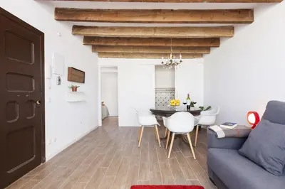 a living room with a blue couch and a table at Aspasios Charming Flats in Barcelona