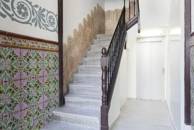 a staircase in a house with a mural on the wall at Aspasios Charming Flats in Barcelona