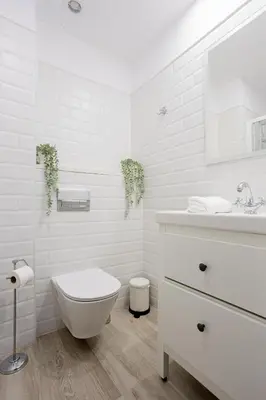 a white bathroom with a toilet and a sink at Bright & Stylish Flat In Trendy Grcia in Barcelona