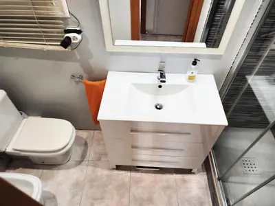 a bathroom with a white sink and a toilet at La Habitación de Santa Eulalia habitación privada in Hospitalet de Llobregat