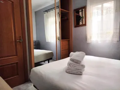 two towels are stacked on a bed in a room at La Habitación de Santa Eulalia habitación privada in Hospitalet de Llobregat