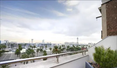 a view of the harbor from the balcony of a building at OLA LIVING - MT - Aire 1 in Barcelona