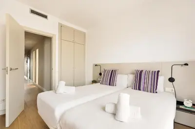 a white bedroom with two large white beds at OLA LIVING - MT - Aire 1 in Barcelona