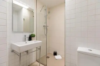 a white bathroom with a sink and a shower at OLA LIVING - MT - Aire 1 in Barcelona