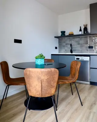 a kitchen with a table and chairs in a room at Quiet Apartment in Sitges Center Steps from Beach in Sitges