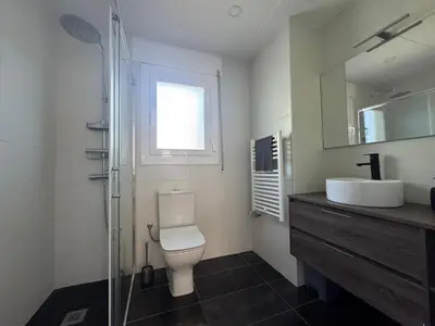 a bathroom with a toilet and a sink and a shower at Vila Viva Mundo in San Cipriano de Vallalta