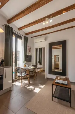 a living room with a table and chairs at Lodging Apartments Almirall Beach 42 in Barcelona
