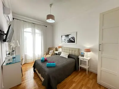 a bedroom with a bed with a blue bowl on it at Gran Via Rooms in Barcelona