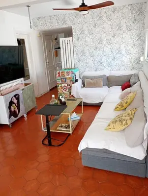 a living room with a couch and a table at Frente al mar con Terraza - Sitges in Sitges