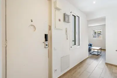 a white hallway with a door and a table at 4182 - AB Poble Sec - Plaza España X in Barcelona