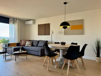 a living room with a couch and a table and chairs at Stay U-nique Apartments at Albigesos in Barcelona