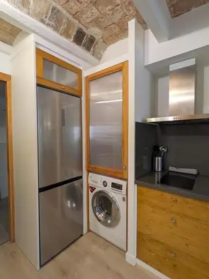 a kitchen with a washer and a washing machine at Barcelona Touch Apartments - Font Honrada in Barcelona