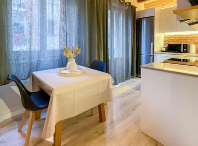 a kitchen with a table with a vase on it at Barcelona Touch Apartments - Fontrodona in Barcelona