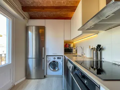 a kitchen with a washer and dryer in it at Barcelona Touch Apartments - Fontrodona in Barcelona