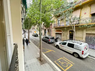 a street with cars parked on the side of the road at Barcelona Touch Apartments - Creu dels Molers in Barcelona