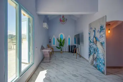 a living room with a painting on the wall at Can cruspinera WITH 6BEEDROOM in Tiana