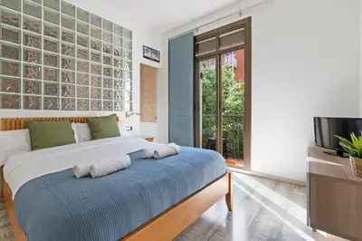 a bedroom with a bed with towels on it at Steps to Sagrada Família AC Elevator in Barcelona