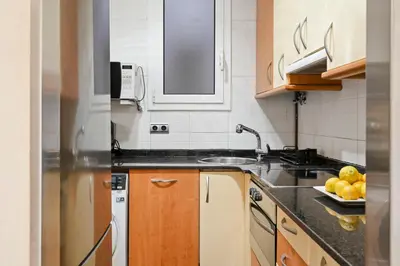 a kitchen with a sink and a counter top at Steps to Sagrada Família AC Elevator in Barcelona