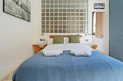a bedroom with a large bed with two pillows at Steps to Sagrada Família AC Elevator in Barcelona