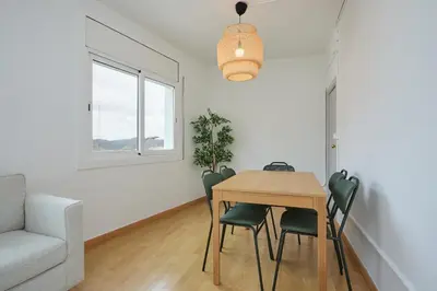 a living room with a table and chairs and a couch at Park Guell in Barcelona