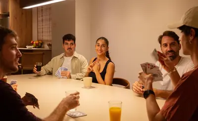a group of people sitting around a table at GG Hostel in Barcelona