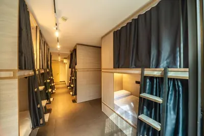 a row of wardrobes with black curtains in a hallway at GG Hostel in Barcelona